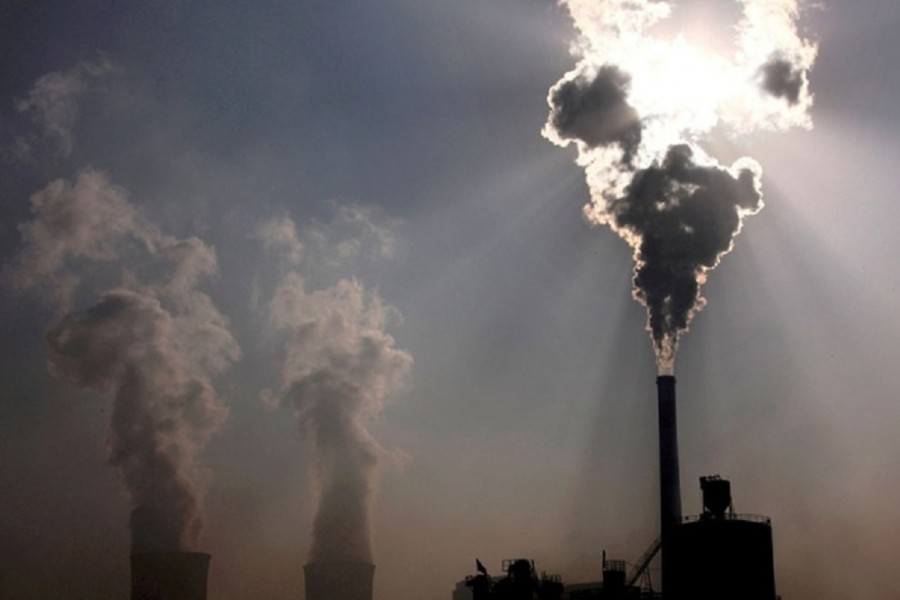 A coal-burning power plant can be seen behind a factory in China's Inner Mongolia Autonomous Region, October 31, 2010. REUTERS