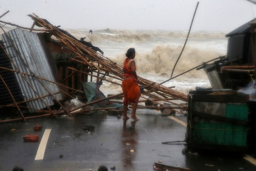 A woman stands next to her stall damaged by heavy winds at a shore ahead of Cyclone Yaas in Bichitrapur in Balasore district in the eastern state of Odisha India, May 26, 2021 - Reuters