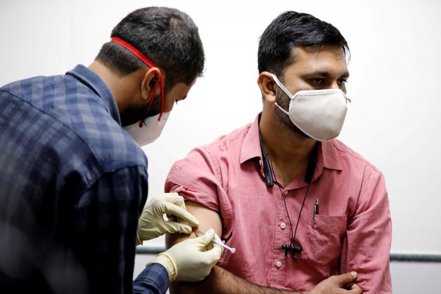 A medic administers COVAXIN, an Indian government-backed experimental Covid-19 vaccine, to a health worker during its trials, at the Gujarat Medical Education & Research Society in Ahmedabad, India on November 26, 2020 — Reuters/Files