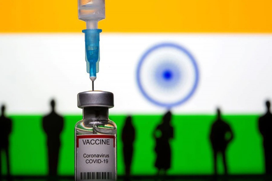 3D-printed small toy figurines, a syringe and vial labelled "coronavirus disease (COVID-19) vaccine" are seen in front of India flag in this illustration taken on May 4, 2021 — Reuters/Files