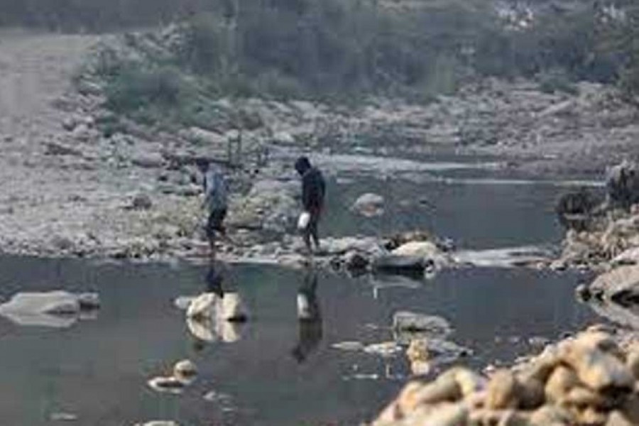 People cross the Tiau river which marks the India-Myanmar border at Zokhawthar village in India's northeastern state of Mizoram, India, March 12, 2021. REUTERS/Rupak De Chowdhuri