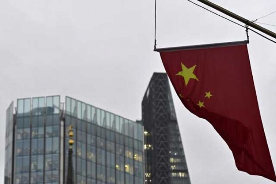 A Chinese national flag flies from the Bank of China in the financial district of the City of London, Britain January 7, 2016. REUTERS