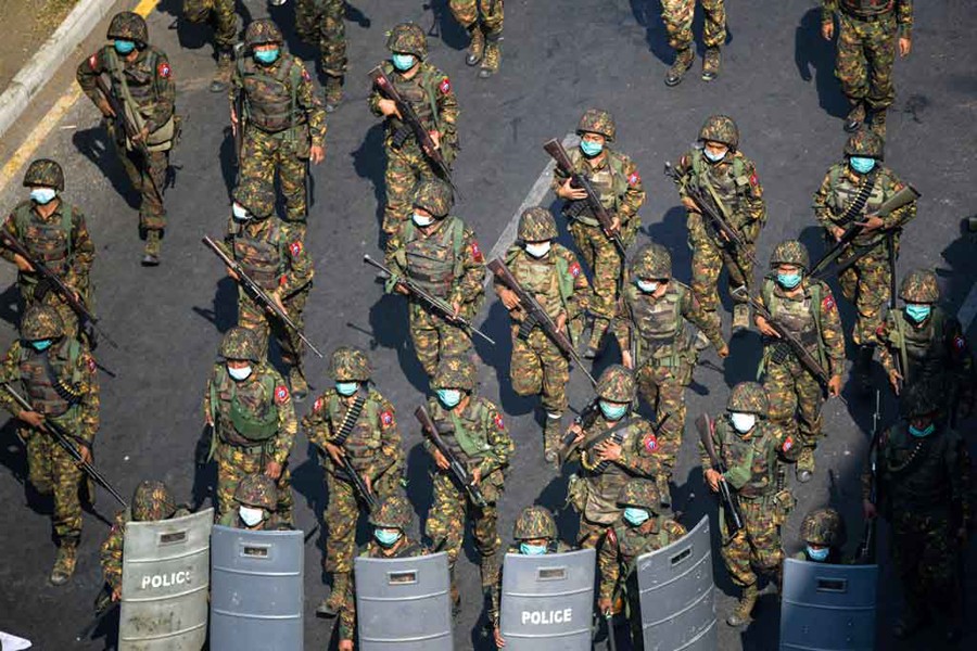 Myanmar soldiers walk along a street during a protest against the military coup in Yangon, Myanmar on February 28, 2021 — Reuters/Files