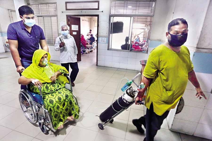 Relatives brought this woman to Mugda Medical College and Hospital in the city on Friday, as she was showing coronavirus symptoms — FE photo by KAZ Sumon