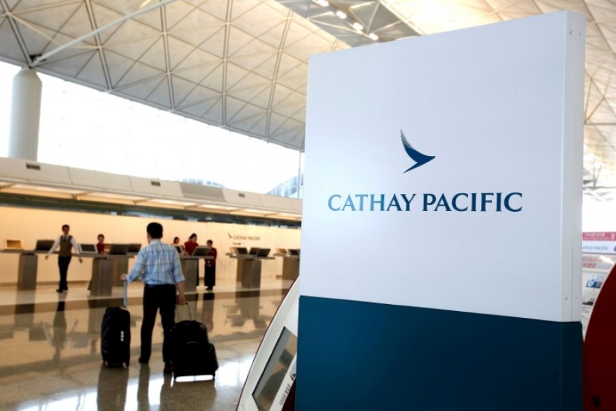 A passenger walks to the First Class counter of Cathay Pacific Airways at Hong Kong Airport in Hong Kong, China April 4, 2018. REUTERS/Bobby Yip/File Photo