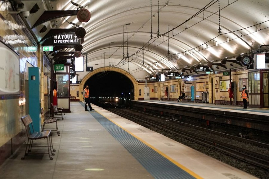 Transport workers stand on mostly deserted train platforms at morning commute hour in the city centre during a lockdown to curb the spread of a coronavirus disease (Covid-19) outbreak in Sydney, Australia on June 28, 2021 — Reuters photo