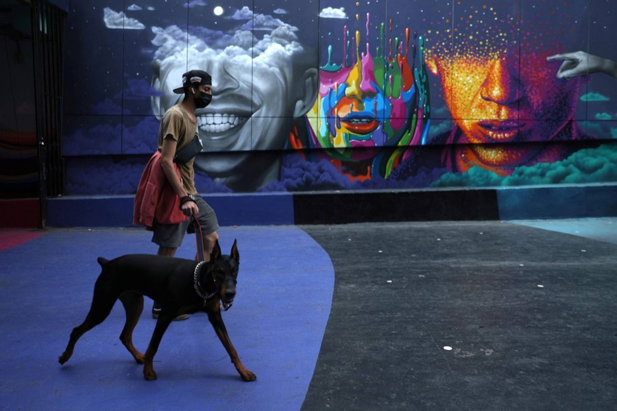 A man walks a dog as lockdown restrictions increase during the coronavirus disease (COVID-19) outbreak, in Santiago, Chile on March 31, 2021 — Reuters/Files