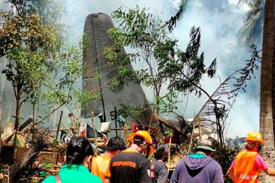 First responders work at the site after a Philippines Air Force Lockheed C-130 plane carrying troops crashed on landing in Patikul, Sulu province, Philippines July 4, 2021. Armed Forces of the Philippines - Joint Task Force Sulu/Handout via REUTERS