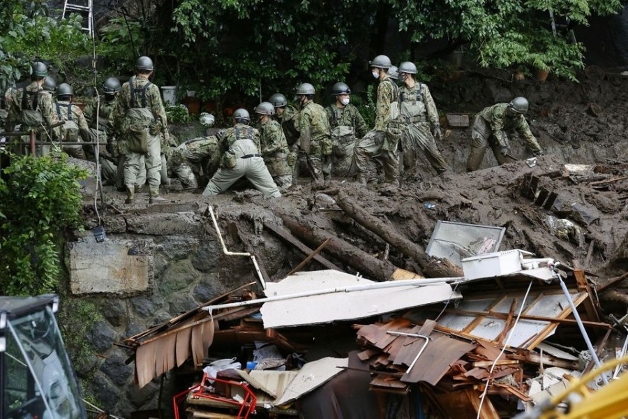 Members of Japanese Self-Defence Forces conduct rescue and search operartion at a mudslide site caused by heavy rain at Izusan district in Atami, west of Tokyo, Japan on July 5, 2021, in this photo taken by Kyodo — Kyodo/via REUTERS