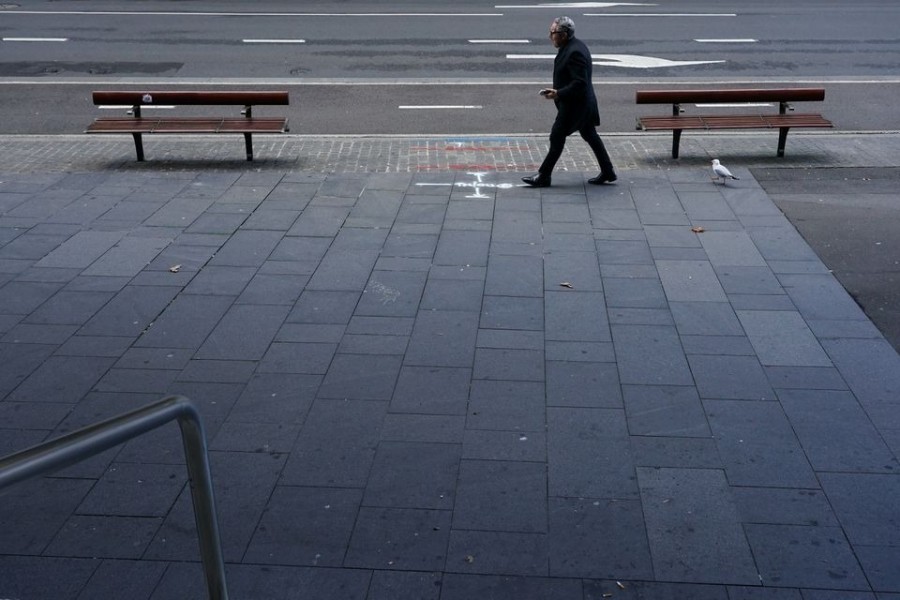 A lone man walks up a deserted street in the city centre during a lockdown to curb the spread of a coronavirus disease (Covid-19) outbreak in Sydney, Australia on July 12, 2021 — Reuters photo