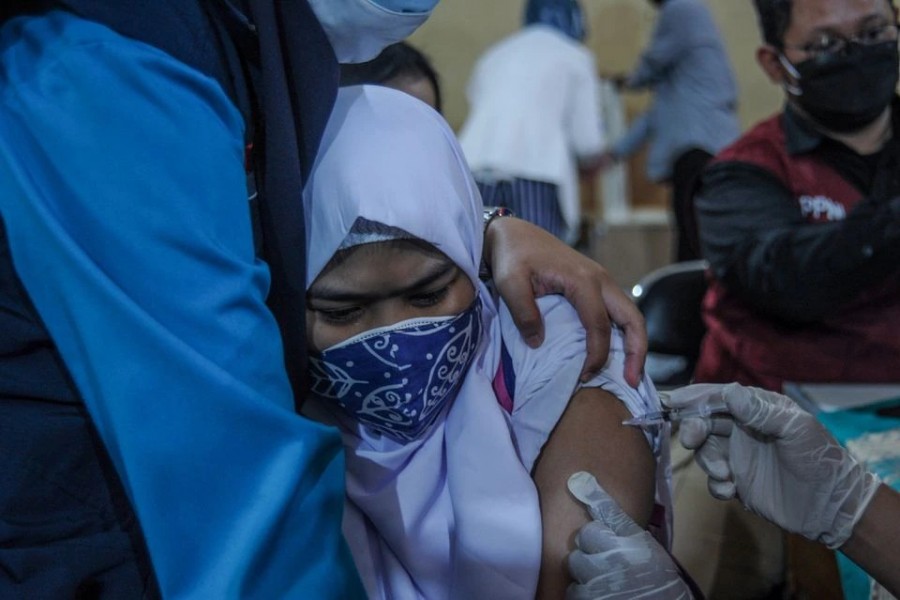 A student reacts as she receives a vaccine against the coronavirus disease (Covid-19) during a mass vaccination program for students as Covid-19 cases surge, in Bandung, West Java Province Indonesia on July 14, 2021 — Reuters photo