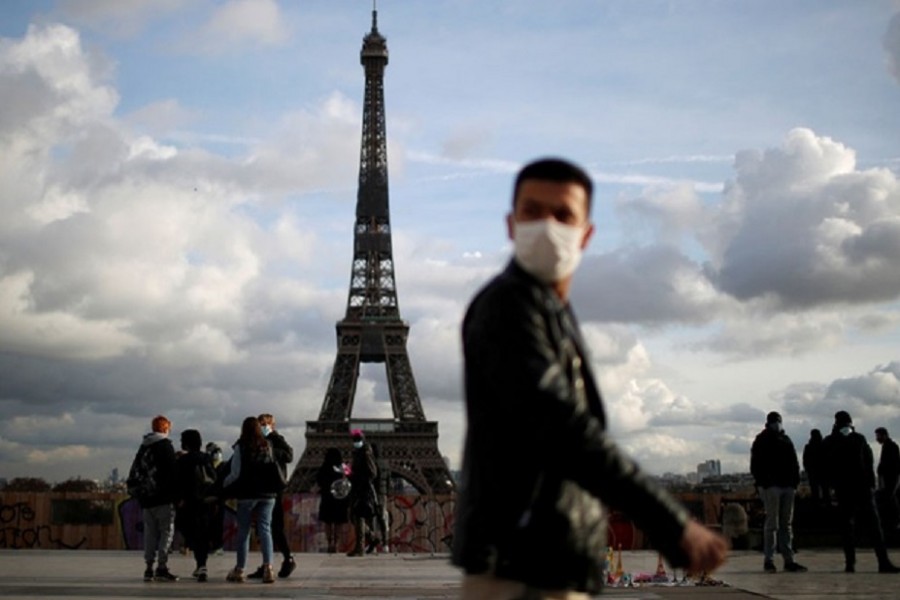 A man, wearing protective face mask, walks at Trocadero square near the Eiffel Tower in Paris amid the coronavirus disease (COVID-19) outbreak in France, Jan 22, 2021. REUTERS