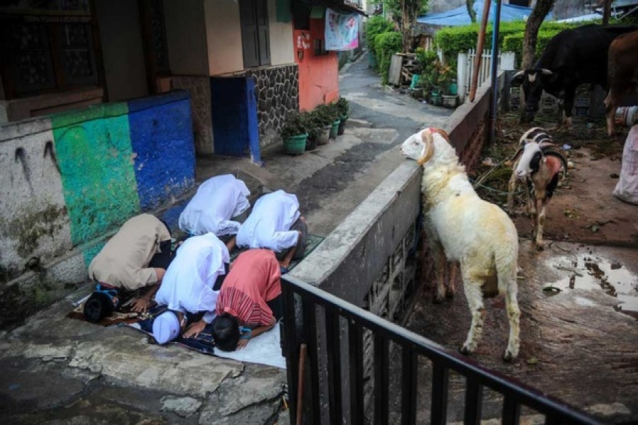 Indonesian Muslims offer Eid al-Adha prayers on the street amid a surge of coronavirus disease (Covid-19) cases in Bandung, West Java province, Indonesia Jul 20, 2021. REUTERS   