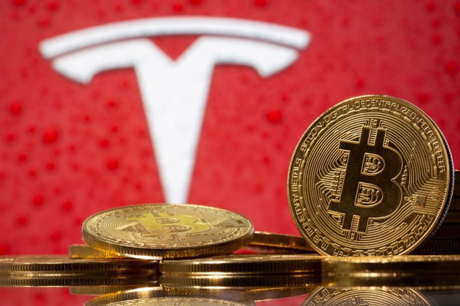 Representations of virtual currency bitcoin are seen in front of Tesla logo in this illustration taken on February 9, 2021 — Reuters/Files