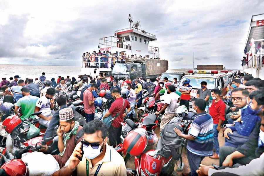 Despite strict lockdown, Eid holidaymakers continue to return to Dhaka braving all odds. The photo of a packed ferry was taken at Doulatdia Ferry Terminal in Rajbari on Saturday — FE photo