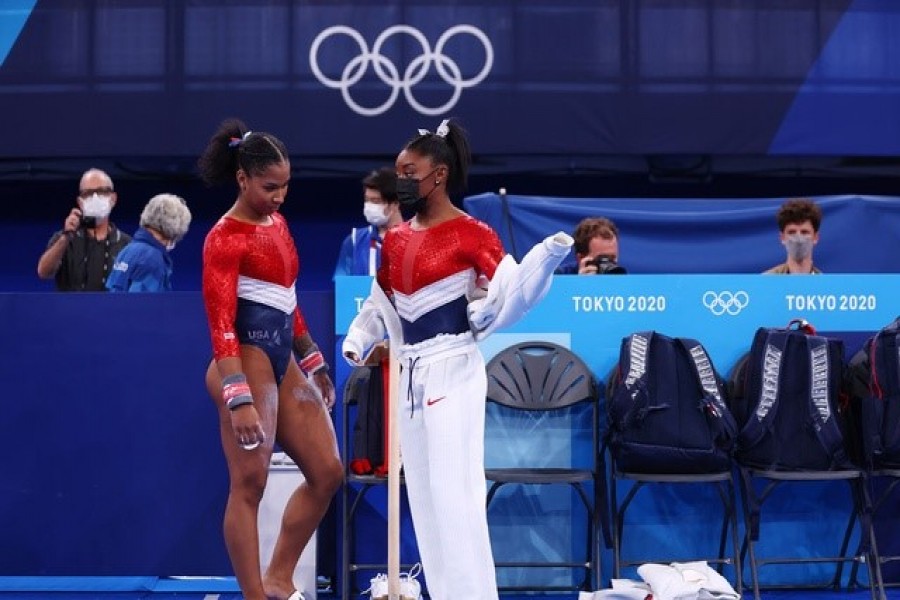 Tokyo 2020 Olympics - Gymnastics - Artistic - Women's Team - Final - Ariake Gymnastics Centre, Tokyo, Japan - July 27, 2021. Simone Biles of the United States wearing a mask with Jordan Chiles of the United States REUTERS/Mike Blake