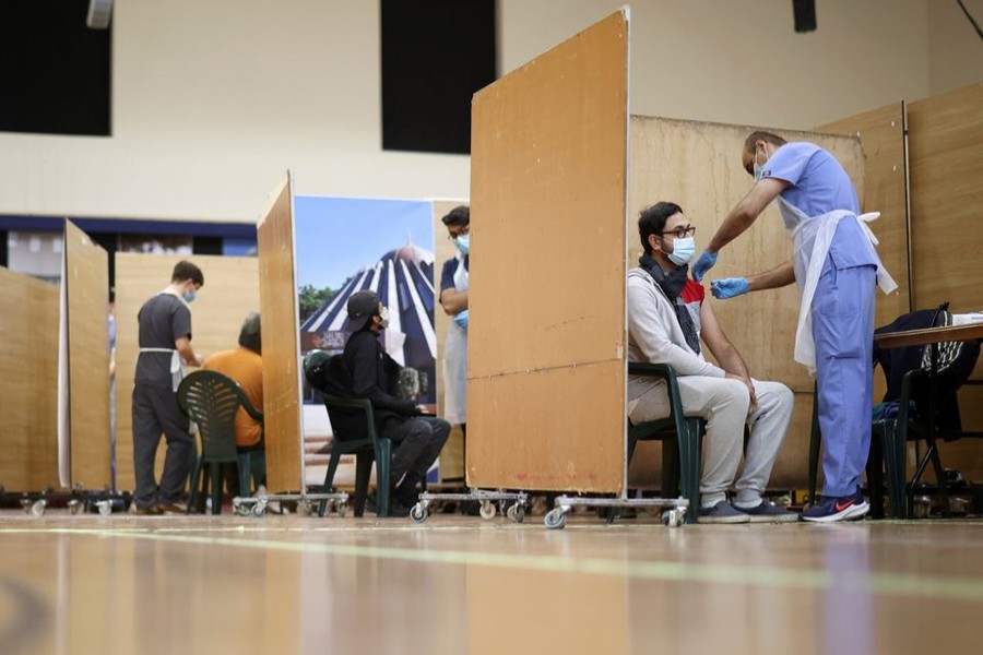 A man receives an injection with a dose of AstraZeneca coronavirus vaccine, at a vaccination centre in Baitul Futuh Mosque, amid the outbreak of coronavirus disease (Covid-19), in London, Britain on March 28, 2021 — Reuters/Files