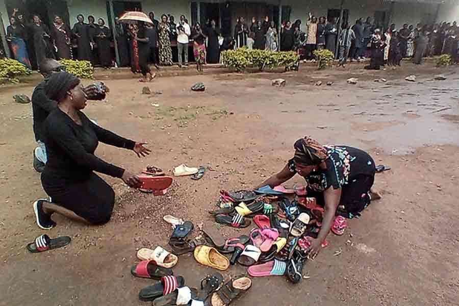 Parents of students abducted at Bethel Baptist High School pray for their safe return around discarded shoes left behind by the children in Nigeria on July 9 this year -Reuters file photo