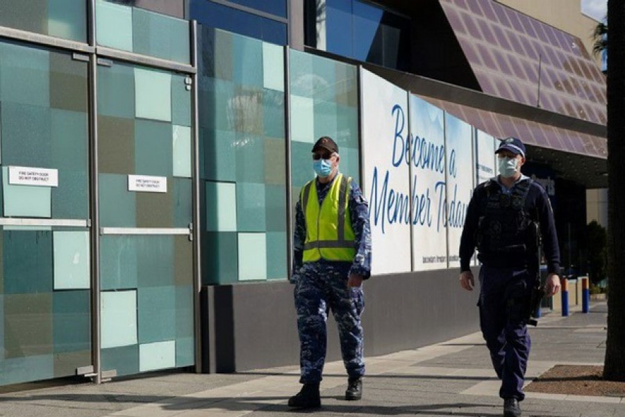 Personnel from the Australian Defence Force and New South Wales Police Force patrol a street in the Bankstown suburb during an extended lockdown to curb the spread of the coronavirus disease (Covid-19) in Sydney, Australia, August 3, 2021 — Reuters