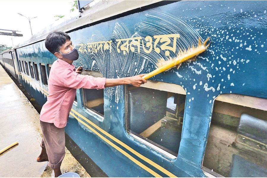 A worker washing coaches at Kamlapur Railway Station in the capital on Monday, as train services will resume across the country tomorrow (Wednesday) — FE Photo by KAZ Sumon