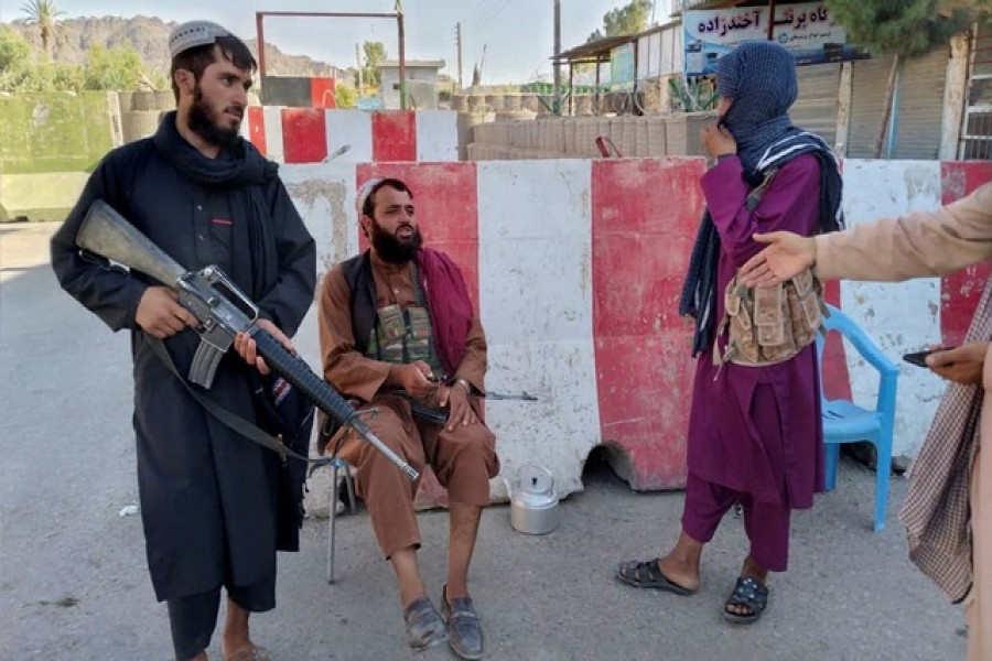 aliban fighters stand guard at a check point in Farah, Afghanistan August 11, 2021. REUTERS