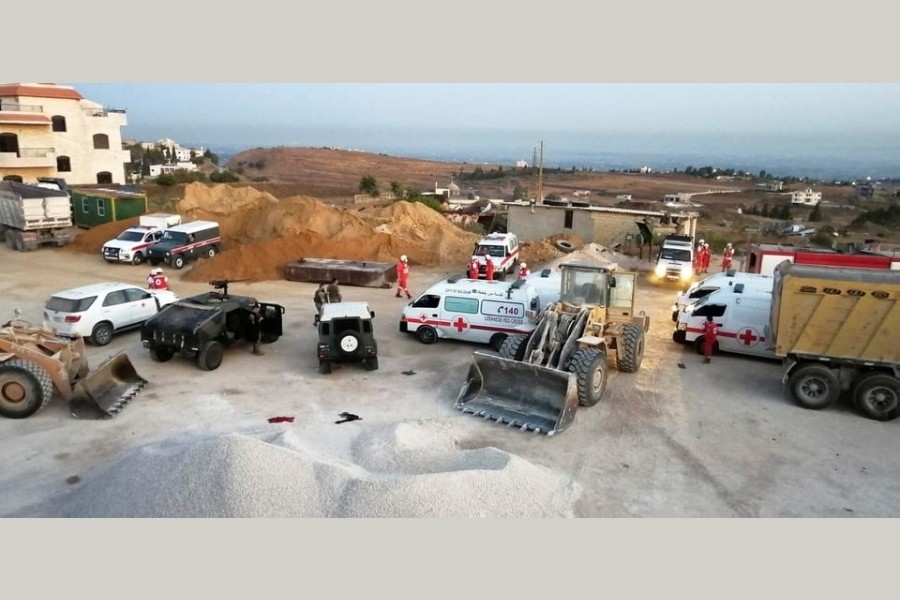 Lebanese army soldiers and Red Cross members are seen near the site of a fuel tanker explosion in Akkar in northern Lebanon, August 15, 2021. REUTERS/Omar Ibrahim