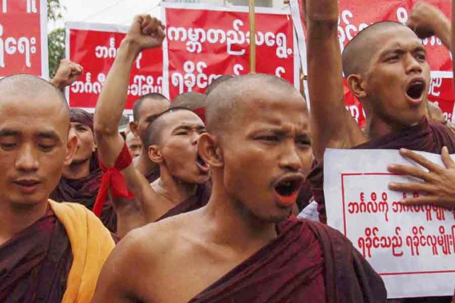 Rakhine Buddhist monks hold posters and placards as they take part in a protest against the use of the phrase ‘Muslim community in Rakhine state’ in Sittwe of Rakhine state, in Myanmar (July 3, 2016). —EPA Photo