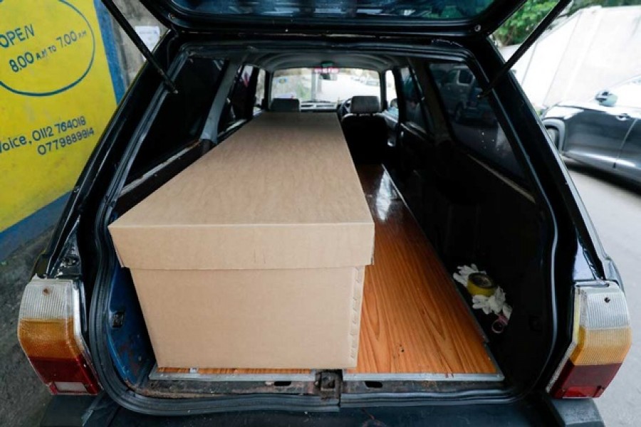 A cardbaord coffin is seen inside a hearse near a mortuary, amid the coronavirus disease (COVID-19) pandemic, on the outskirts of Colombo, Sri Lanka Jul 14, 2021. REUTERS/Dinuka Liyanawatte