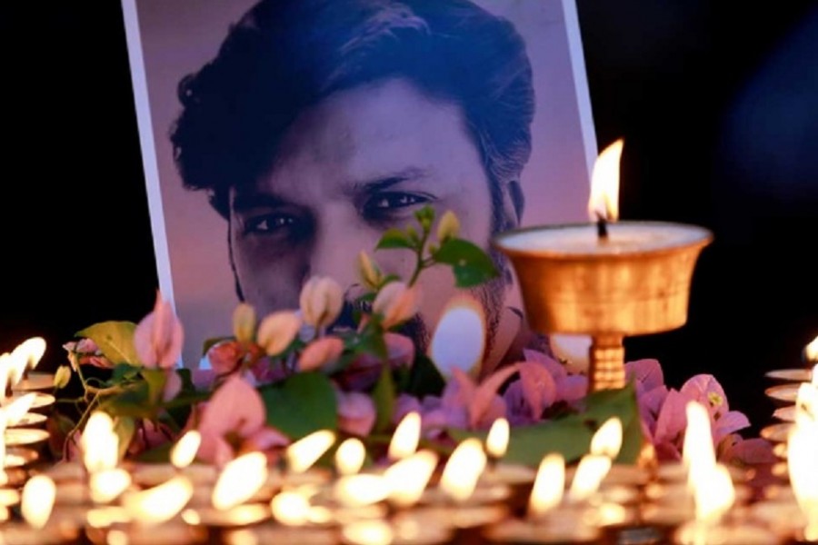 Butter lamps lit by Nepali photographers burn near the photograph of Reuters journalist Danish Siddiqui, who was killed while covering a clash between Afghan security forces and Taliban fighters, at Swayambhunath Stupa, a UNESCO world heritage site, in Kathmandu, Nepal July 20, 2021. REUTERS/Navesh Chitrakar