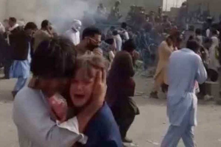 People run from gunfire at Kabul airport, Afghanistan, August 19, 2021 in this still image taken from a video. AAMAJ NEWS/via REUTERS