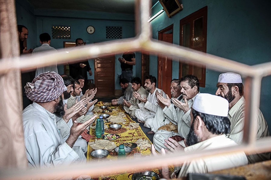 Kabuliwalas in Kolkata are praying before their meal in 2015. They used to dine on the dastarkwhan —Scroll.In  Photo   