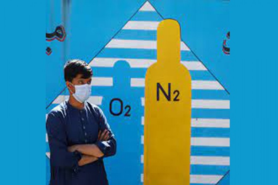 A man waits outside a factory to get his oxygen cylinder refilled, amidst the spread of the coronavirus disease (COVID-19) in Kabul, Afghanistan June 15, 2021. REUTERS