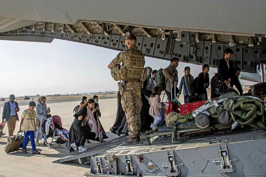 British citizens and dual nationals residing in Afghanistan board a military plane for evacuation from Kabul airport, Afghanistan August 16, 2021, in this handout picture obtained by Reuters on August 17, 2021. LPhot Ben Shread/UK MOD Crown copyright 2021/Handout via REUTERS