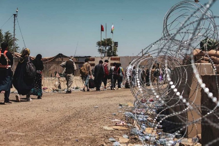 Evacuees walk to be processed during an evacuation at Hamid Karzai International Airport, Kabul, Afghanistan, August 25, 2021. US Marine Corps/Sgt. Isaiah Campbell/Handout via REUTERS