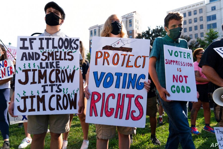 Demonstrators hold signs during a march for voting rights, marking the 58th anniversary of the March on Washington, Aug. 28, 2021, in Washington - AP