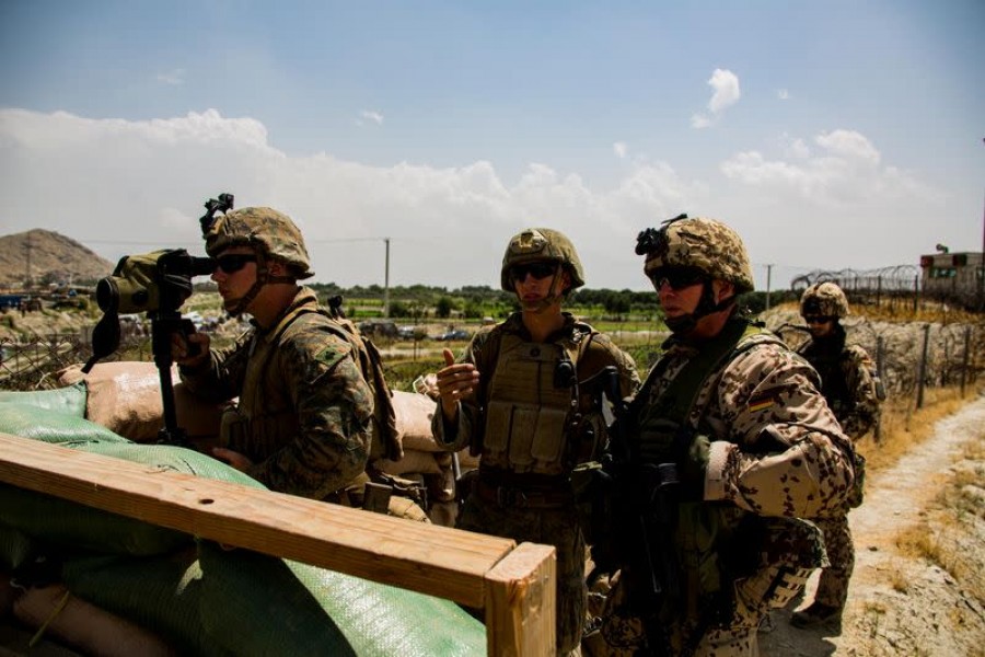 US Marines and German service member watch an entry gate during an evacuation at Hamid Karzai International Airport, Kabul, Afghanistan on August 28, 2021 — US Marine Corps Handout Via Reuters