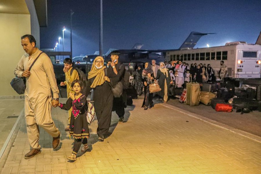 Evacuees from Afghanistan arrive at Al-Udeid airbase in Doha, Qatar in this recent undated handout — Government Communications Office of the State of Qatar Handout via REUTERS