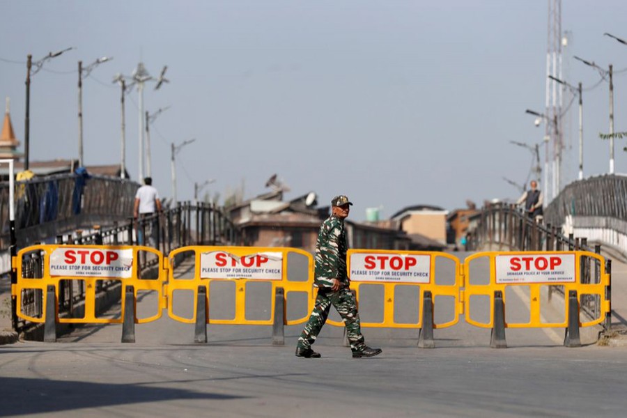 An Indian security force personnel member walks past barricades during restrictions imposed by authorities following the death of Syed Ali Shah Geelani, a Kashmiri veteran separatist politician, in Srinagar on September 3, 2021 — Reuters photo