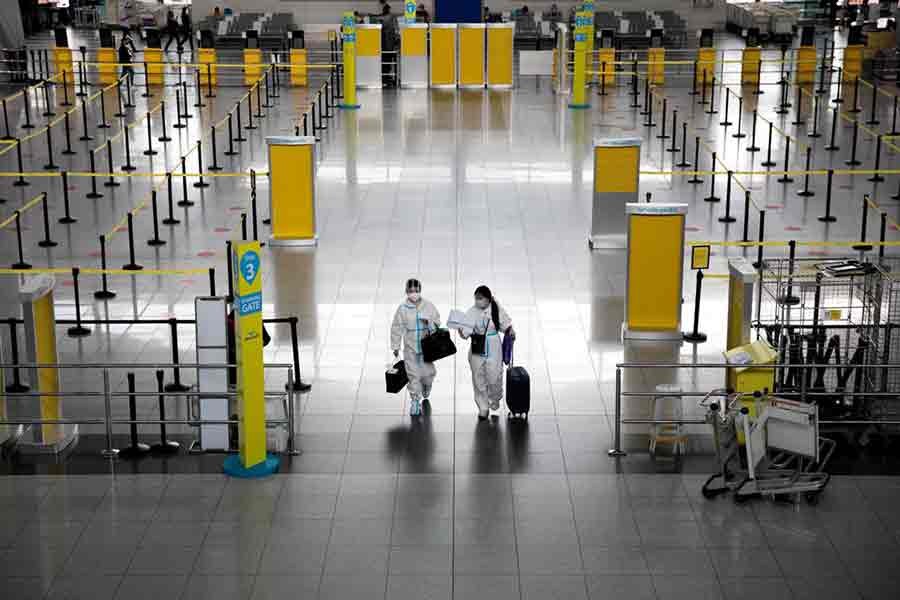 Passengers walking inside the Ninoy Aquino International Airport in the Philippines on January 14 this year wearing hazmat suits for protection against the coronavirus disease (COVID-19) -Reuters file photo