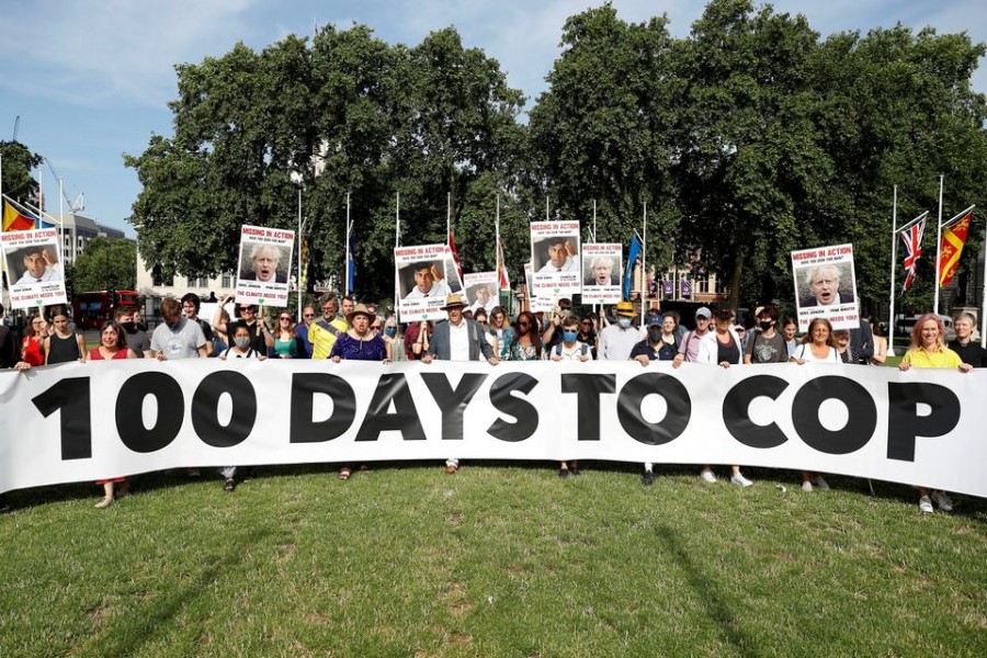 Protesters from the Climate Coalition demonstrate, with 100 hundred days to go before the start of the COP26 climate summit, in Parliament Square, London, Britain, July 23, 2021. REUTERS/Peter Nicholls/File Photo