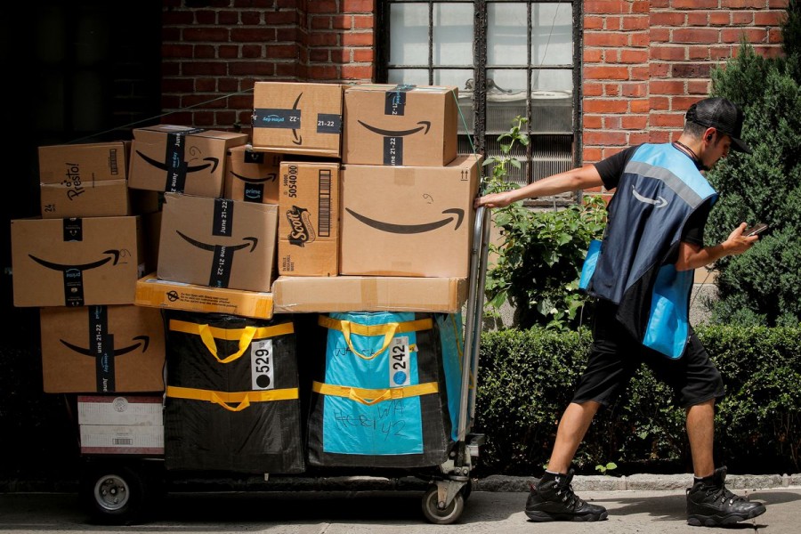 An Amazon delivery worker pulls a delivery cart full of packages during its annual Prime Day promotion in New York City, US, June 21, 2021 — Reuters/Brendan McDermid TPX IMAGES OF THE DAY