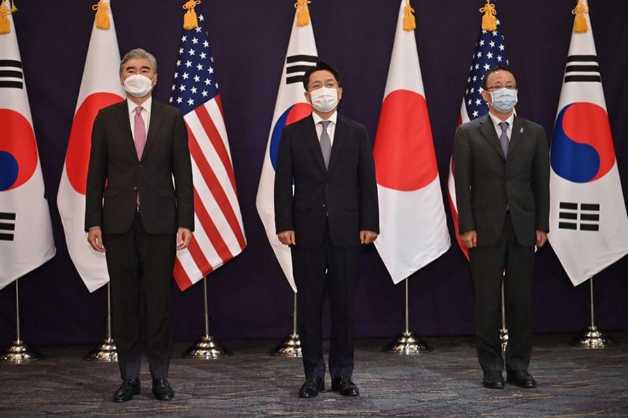 Sung Kim (L), US Special Representative for North Korea, Noh Kyu-duk (C), South Korea's Special Representative for Korean Peninsula Peace and Security Affairs, and Takehiro Funakoshi (R), Director-General of the Asian and Oceanian Affairs Bureau of the Ministry of Foreign Affairs of Japan, pose for a photo during their trilateral meeting at a hotel in Seoul, South Korea on June 21, 2021 — Pool via Reuters/Files