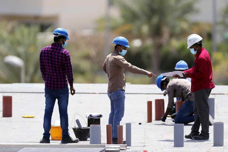 Workers wearing protective face masks work on a residential construction site, following the outbreak of coronavirus disease (COVID-19), in Dubai of United Arab Emirates on April 14 last year –Reuters file photo