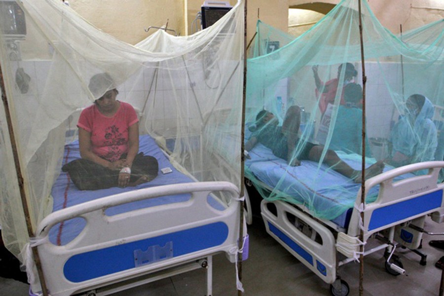 Dengue-infected patients sit under the mosquito nets after being hospitalised at Tej Bahadur Sapru Hospital in Prayagraj, in the northern state of Uttar Pradesh, India, Sept 13, 2021. REUTERS/Jitendra Prakash