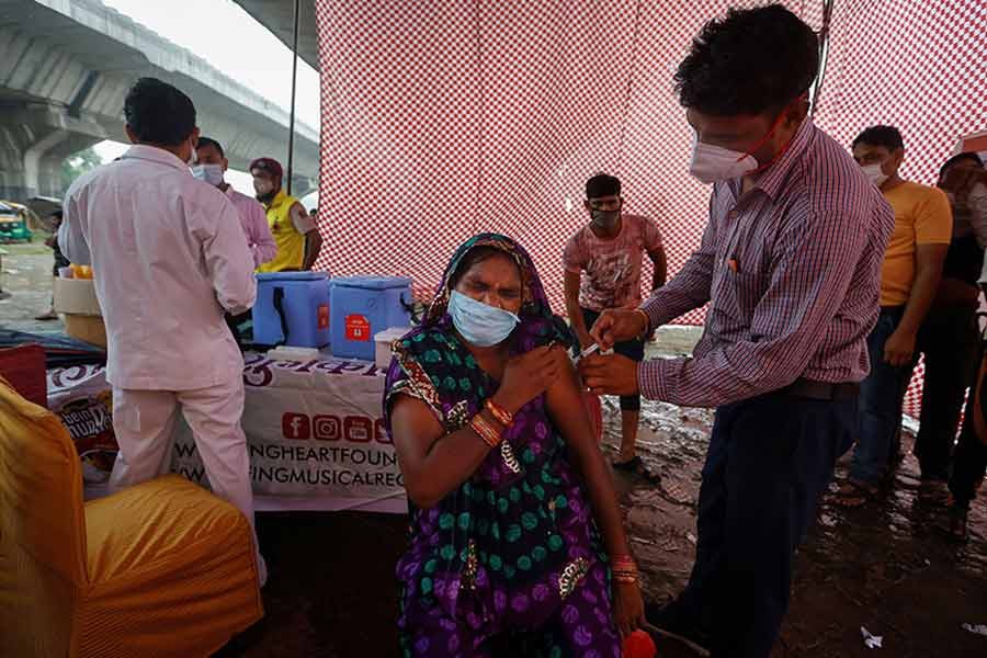 A woman receiving a dose of COVAXIN coronavirus disease (COVID-19) vaccine at an under-construction flyover in New Delhi of India on August 31 this year –Reuters file photo