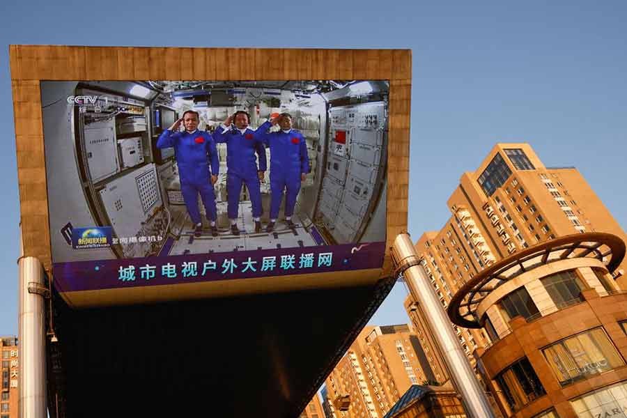 A giant screen at a shopping mall in Beijing on June 18 this year showing Chinese astronauts Nie Haisheng (C), Liu Boming (R), and Tang Hongbo of the Shenzhou-12 mission inside the Tianhe core module of China's space station -Reuters file photo