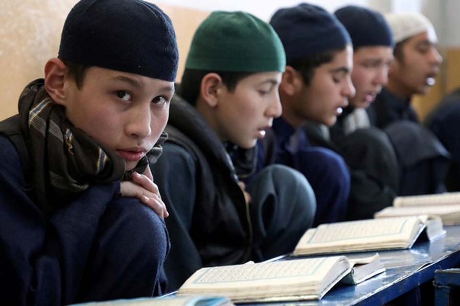 Afghan boys read the Koran in a madrasa, or religious school, during the Muslim holy month of Ramadan in Kabul, Afghanistan April 18, 2021. REUTERS/Omar Sobhani