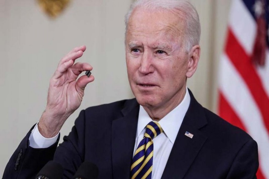 US President Joe Biden holds a semiconductor chip as he speaks prior to signing an executive order, aimed at addressing a global semiconductor chip shortage, in the State Dining Room at the White House in Washington, US, February 24, 2021 — Reuters/Jonathan Ernst