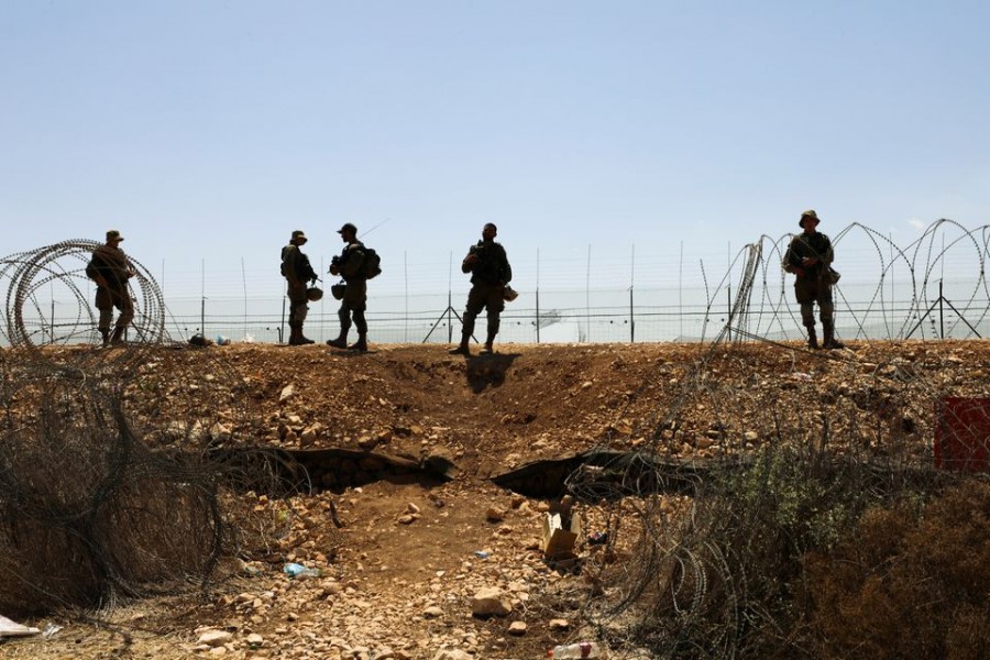 Israeli soldiers guard along a fence leading to the Israeli-occupied West Bank, as part of search efforts to capture six Palestinian men who had escaped from Gilboa prison earlier this week, by the village of Muqeibila in northern Israel September 9, 2021. REUTERS/Ammar Awad/File Photo