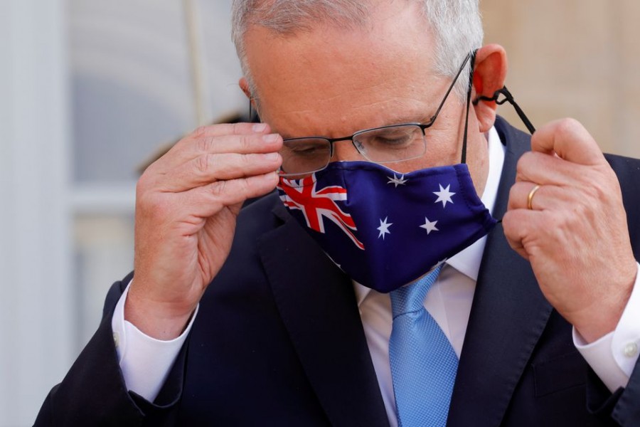 Australian Prime Minister Scott Morrison adjusts his mask during a news conference he holds with French President Emmanuel Macron in front of the Elysee Palace in Paris, France, June 15, 2021 — Reuters /Pascal Rossignol